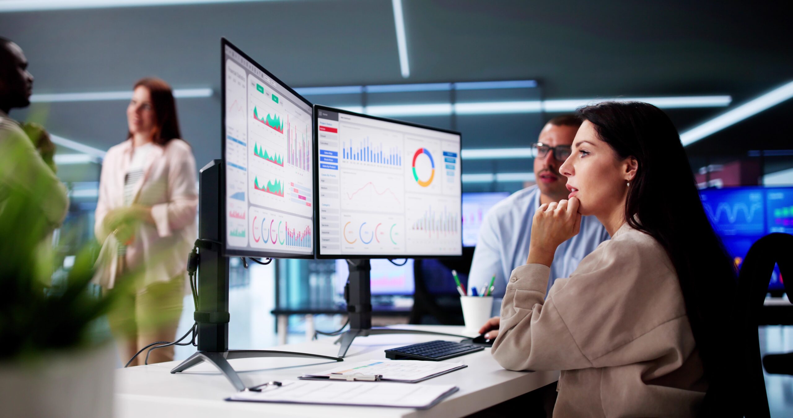 Data analysts reviewing dashboards on dual monitors to explore MongoDB data and support data driven decision making