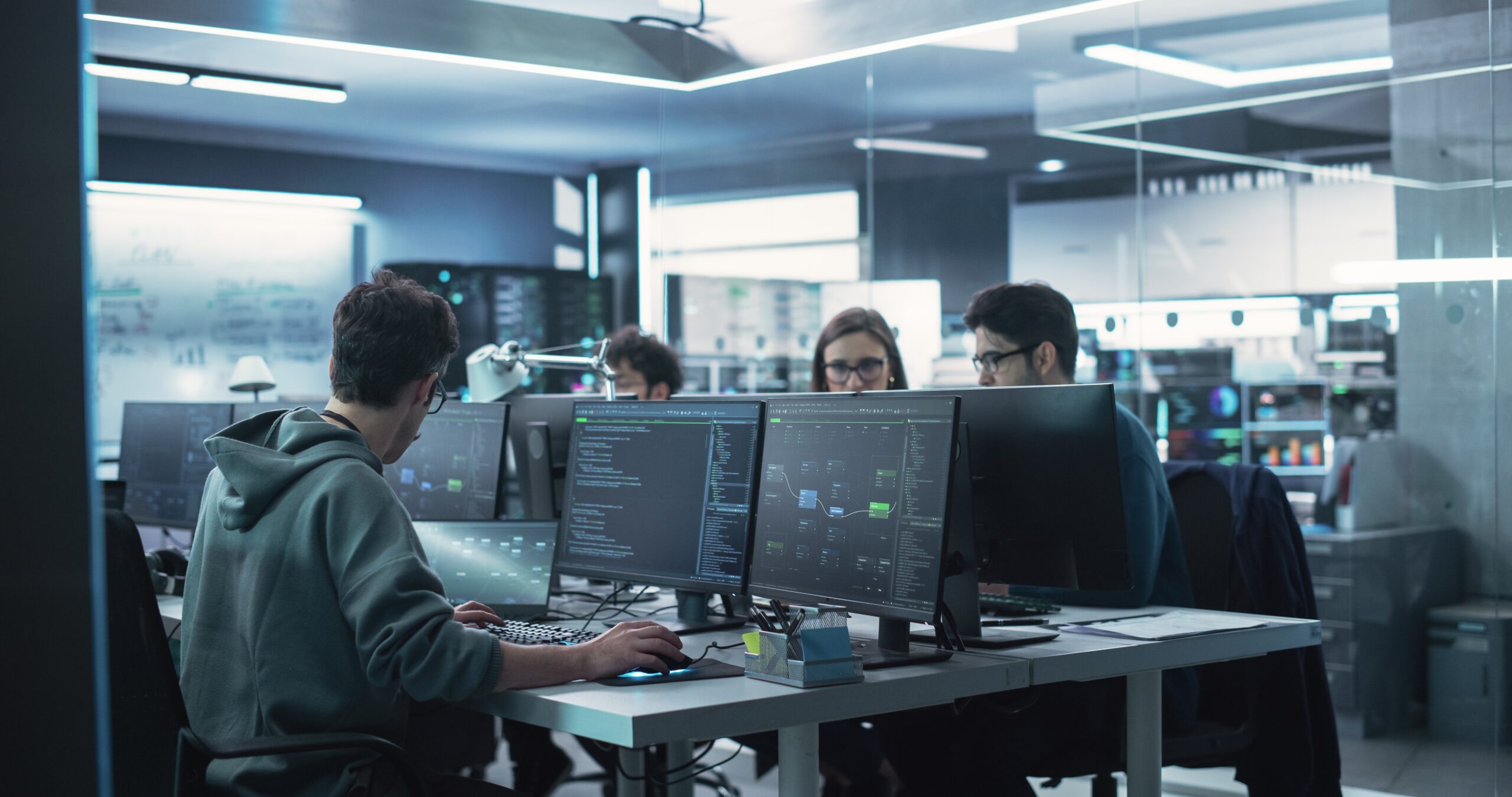 Developers collaborating at their workstations on a MongoDB project during a team planning session.